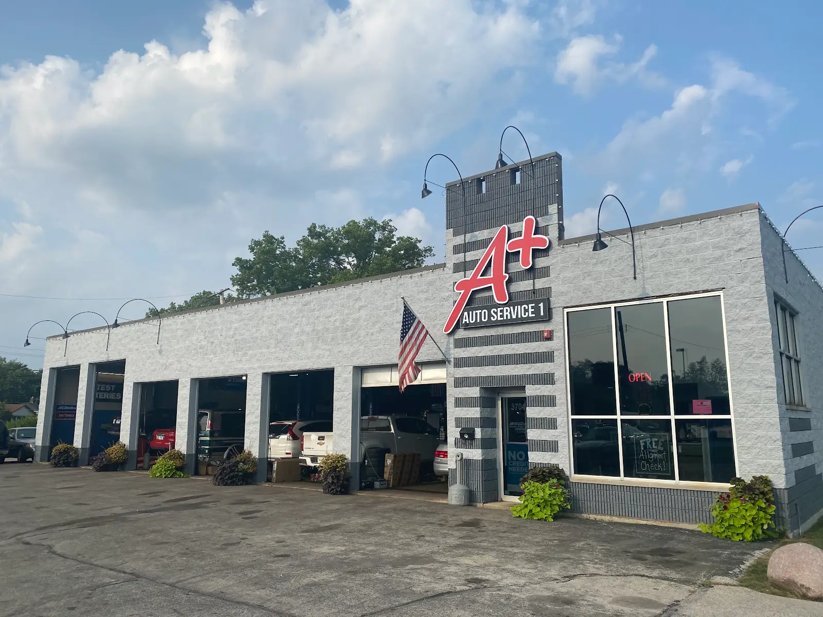 Exterior of the A Plus Auto Service shop in Midlothian, Illinois, showing its updated signage and service bays